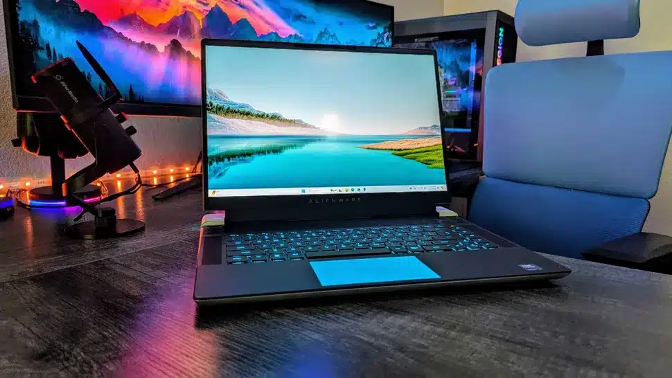 High-performance gaming laptop with RGB keyboard and dual monitors on desk setup